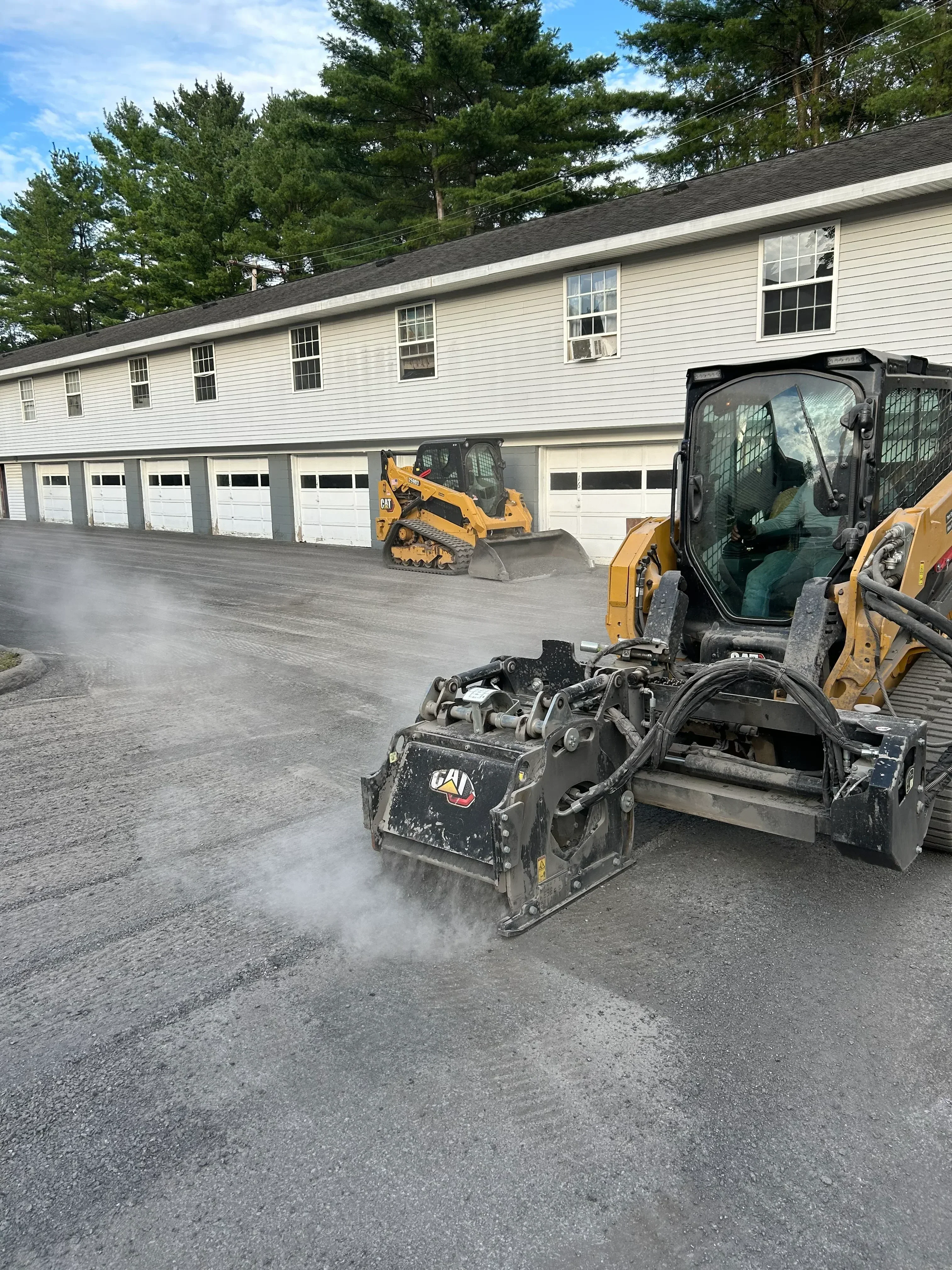 Asphalt milling machine grinding pavement surface with recycled material discharge