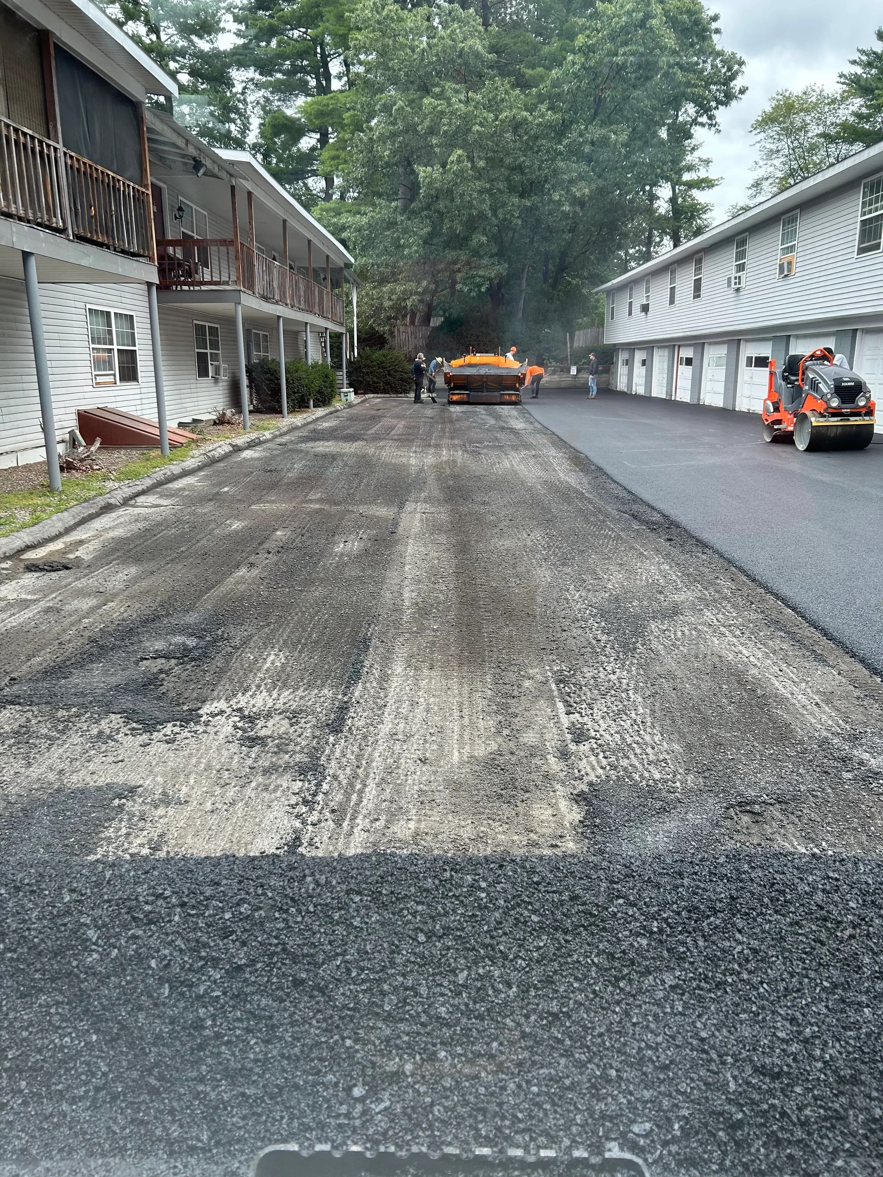 Commercial asphalt driveway high-pressure cleaning and restoration work