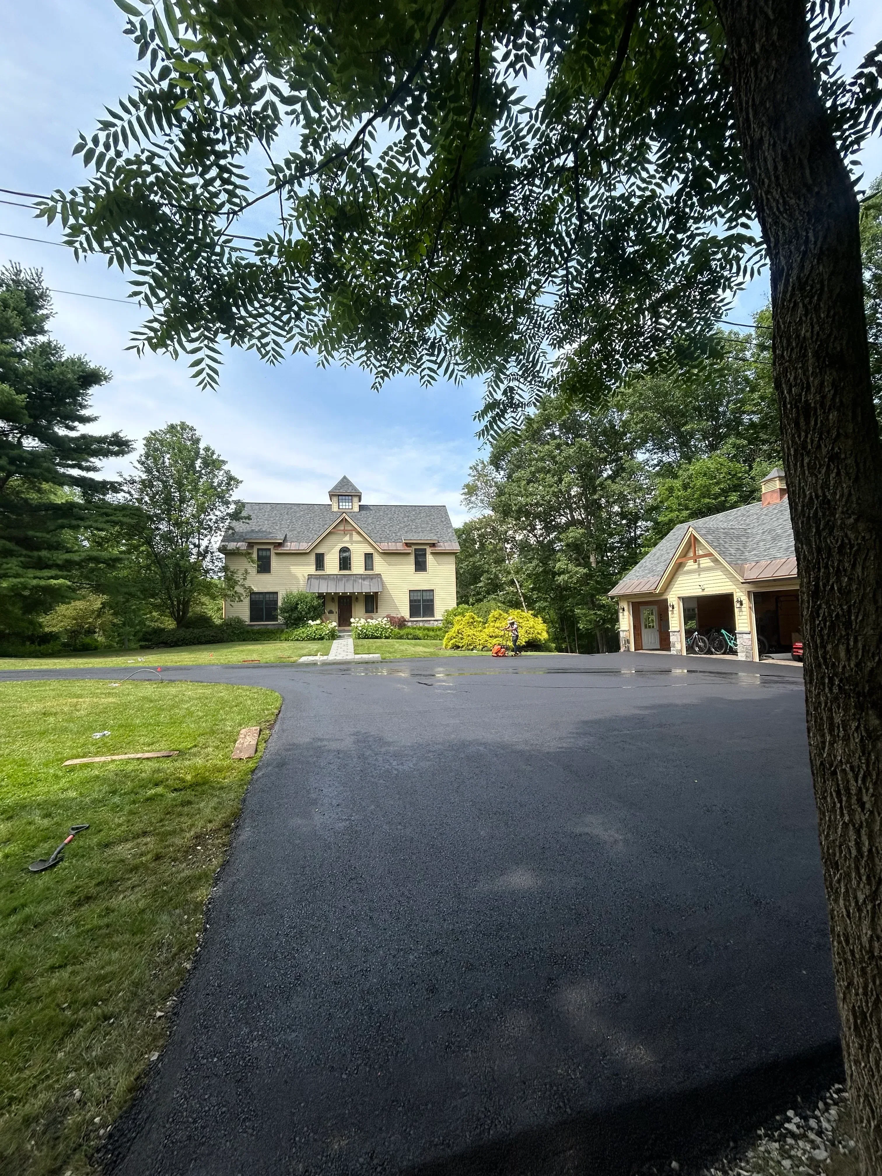 New asphalt driveway with smooth dark surface and clean edges at residential property